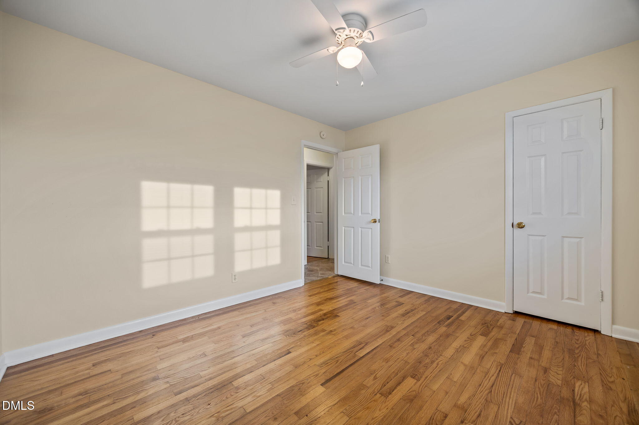 131 Fairview Village Road Dunn, NC 28334 - Photo 11 of 43 an empty room with wooden floor and windows