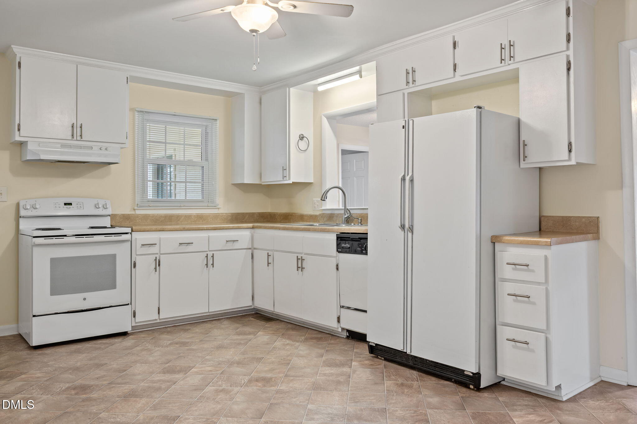131 Fairview Village Road Dunn, NC 28334 - Photo 18 of 43 a kitchen with white cabinets and white appliances