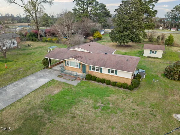 an aerial view of a house with a yard