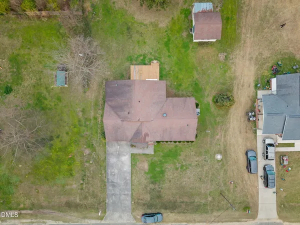 an aerial view of a house with garden space and lake view