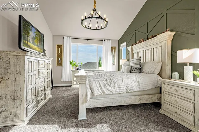 a bedroom with a bed a flat screen tv and dresser