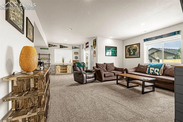 a living room with furniture a rug and a window