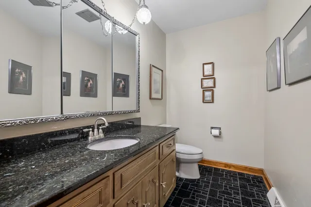 a bathroom with a sink a toilet a shower and a mirror