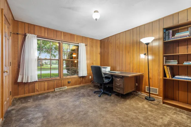 a view of workspace with furniture and window