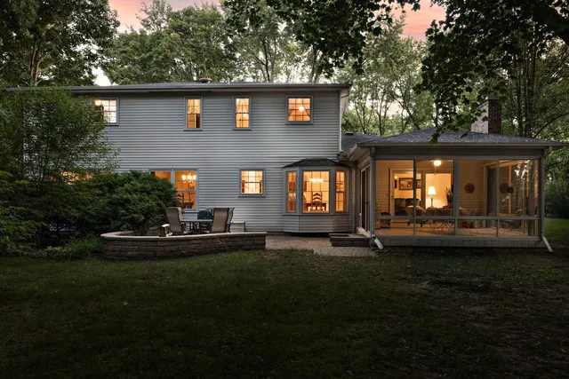 a view of a house with backyard and sitting area