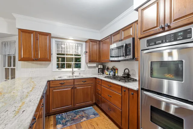 a kitchen with stainless steel appliances granite countertop a stove and a sink