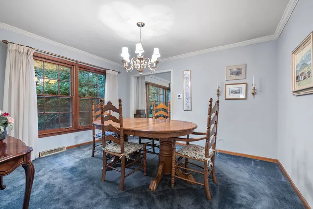 a view of a dining room with furniture wooden floor and chandelier