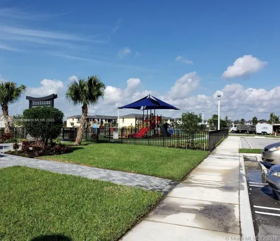 a swimming pool view with a seating space