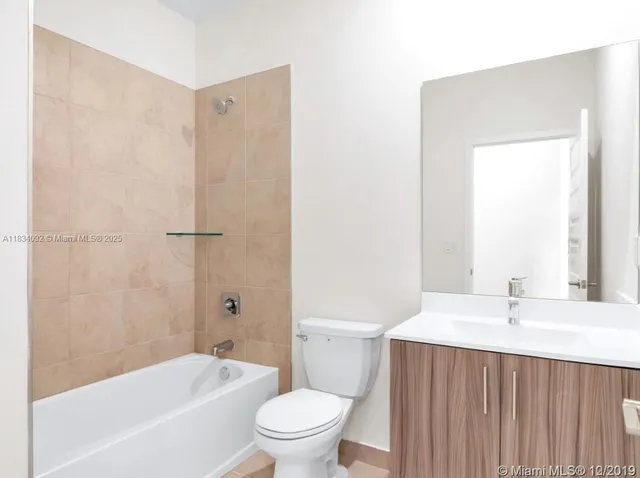 a bathroom with a sink a toilet and a bathtub