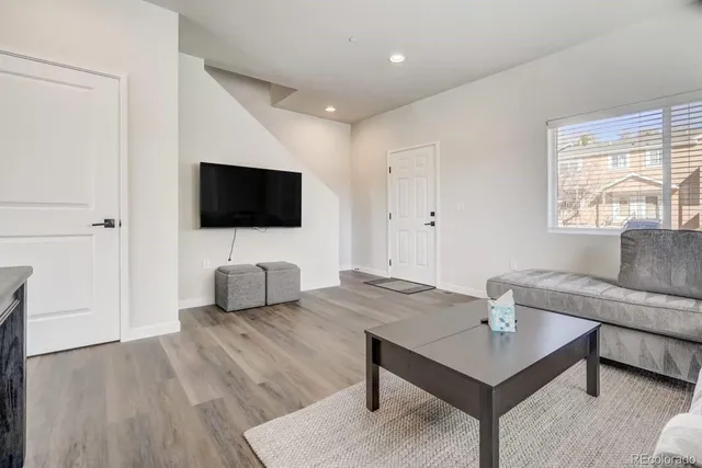 a view of a kitchen area with furniture and wooden floor