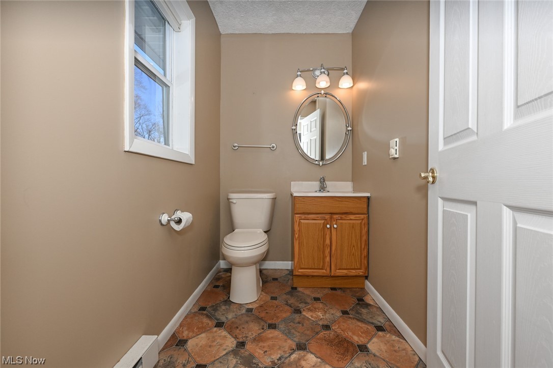 1509 McTaggart Road Stow, OH 44224 - Photo 13 of 30 Bathroom with vanity, a textured ceiling, toilet, and tile floors