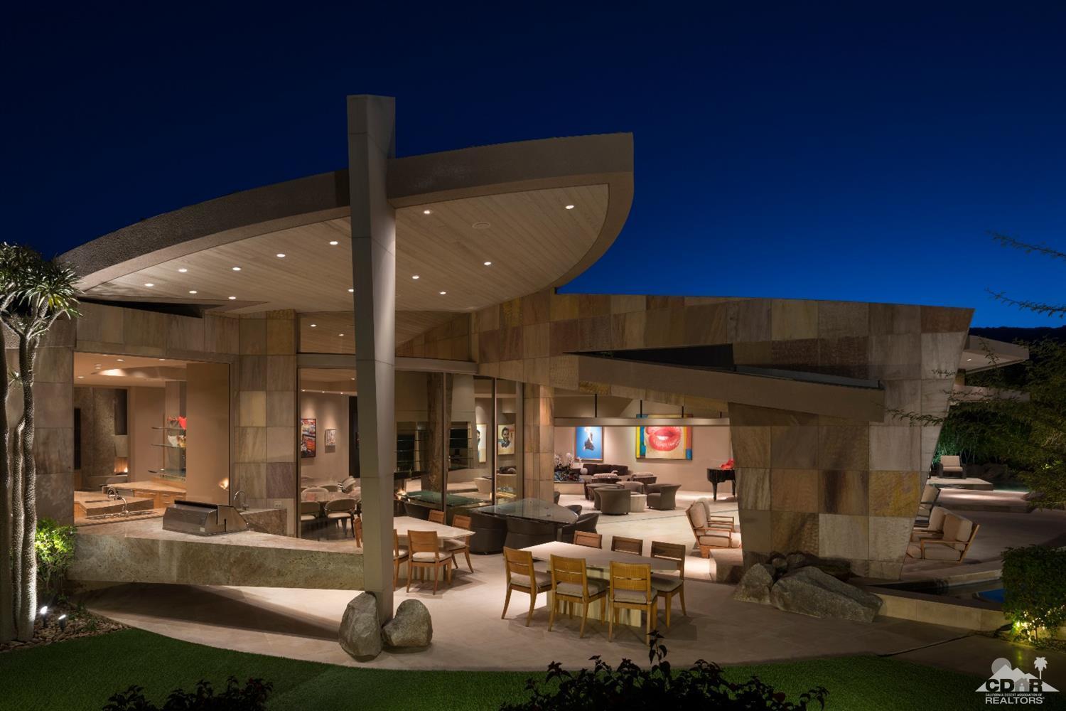 a living room with patio furniture and a fireplace