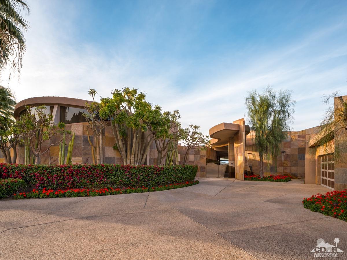632 Pinnacle Crest Palm Desert, CA 92260 - Photo 14 of 52 a front view of a house with a yard and a garage
