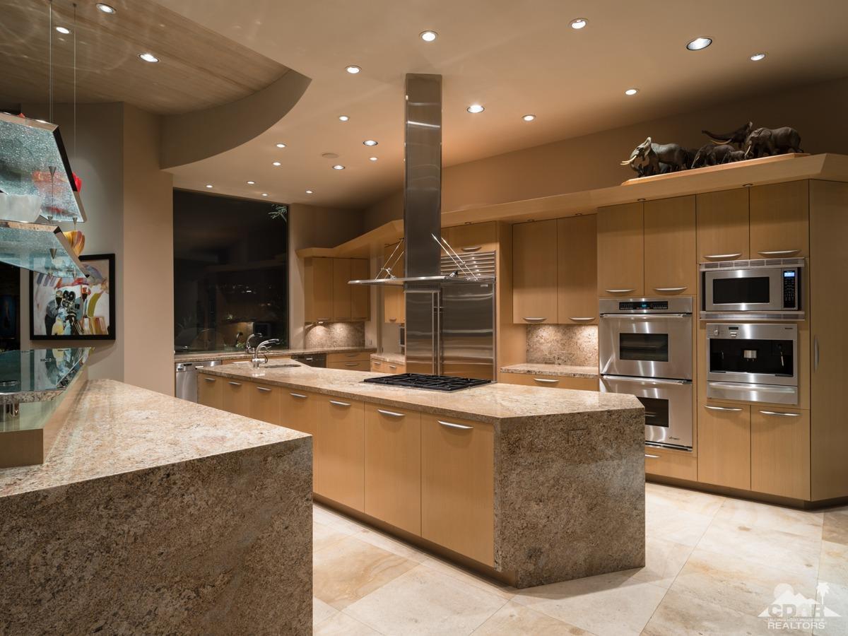632 Pinnacle Crest Palm Desert, CA 92260 - Photo 29 of 52 a large kitchen with stainless steel appliances granite countertop a large counter top and a fireplace