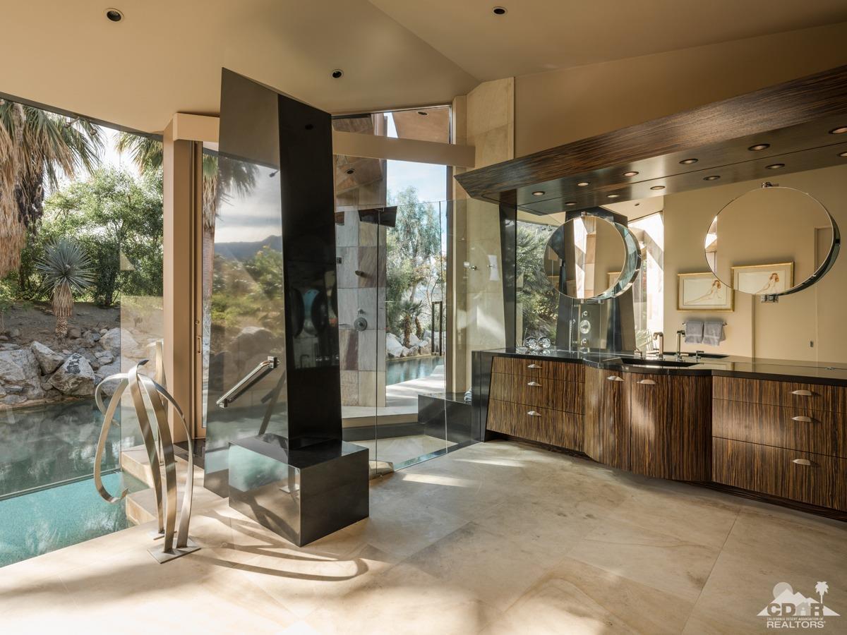 632 Pinnacle Crest Palm Desert, CA 92260 - Photo 35 of 52 a spacious bathroom with a glass shower sink and mirror