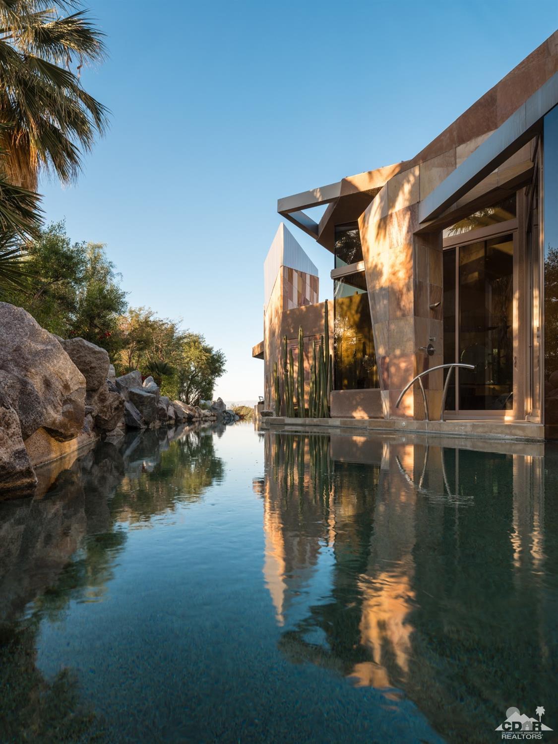 632 Pinnacle Crest Palm Desert, CA 92260 - Photo 37 of 52 a lake view with boat and palm trees