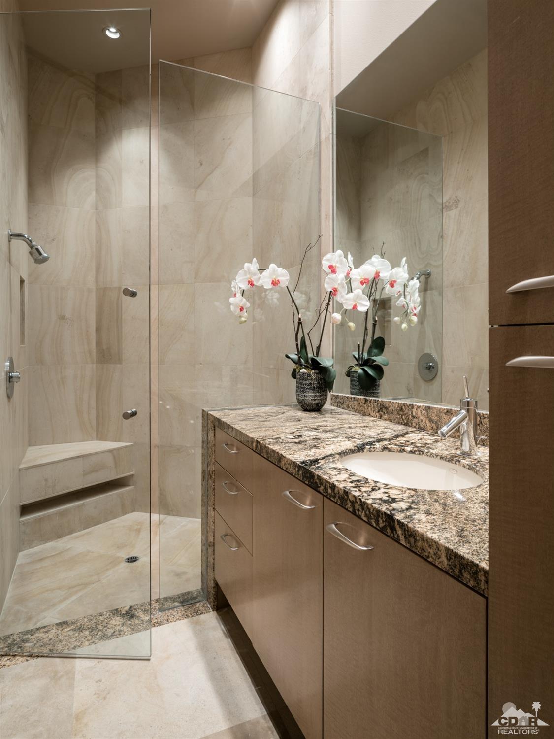 632 Pinnacle Crest Palm Desert, CA 92260 - Photo 48 of 52 a bathroom with a granite countertop sink and a mirror