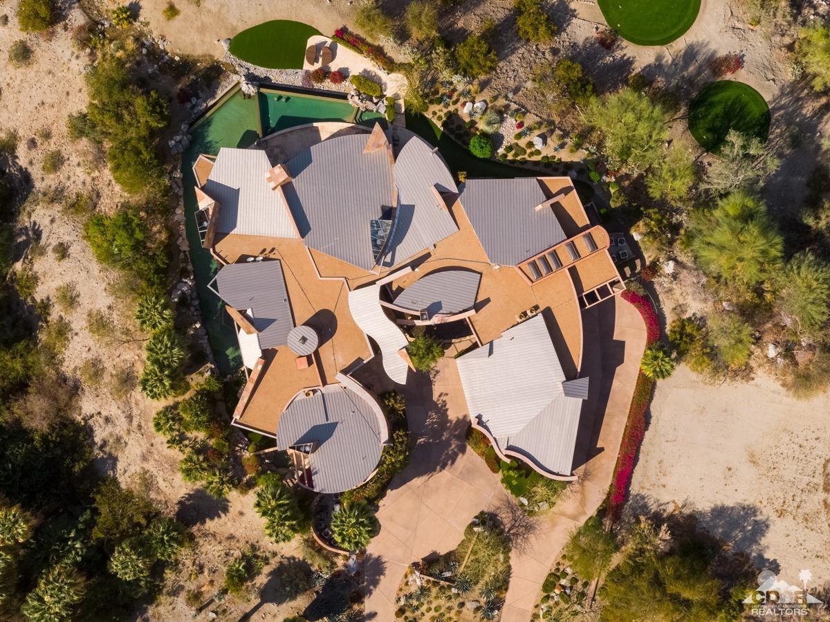 632 Pinnacle Crest Palm Desert, CA 92260 - Photo 9 of 52 an aerial view of a backyard with fountain and large trees