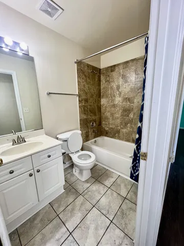 a bathroom with a sink mirror vanity and toilet