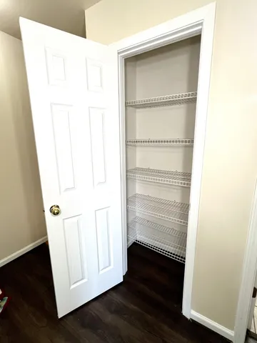 a view of walk in closet with empty racks