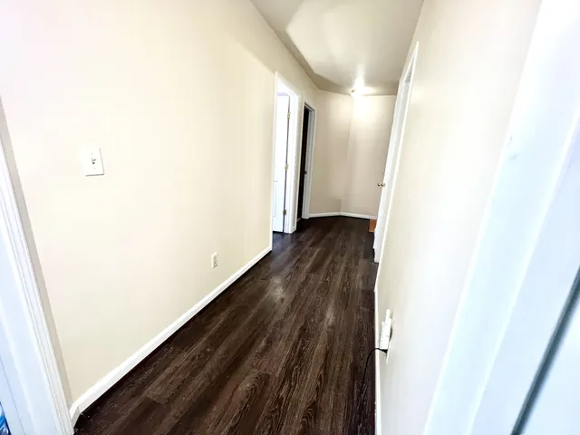 a view of hallway with wooden floor