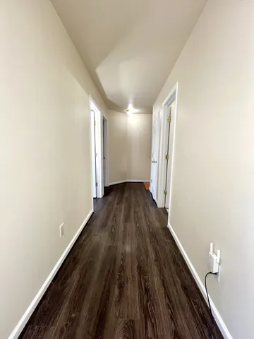 a view of a room with wooden floor and staircase
