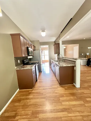 a view of a kitchen with wooden floor