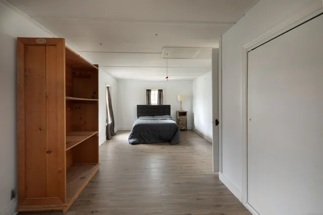 a living room with furniture and a walk in closet