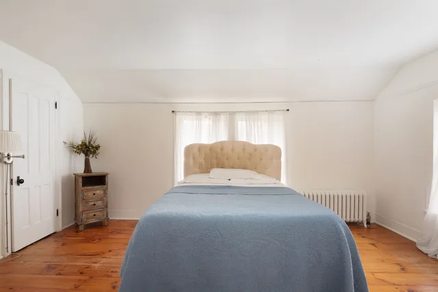 a bedroom with a bed and a table