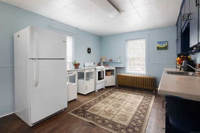 a white refrigerator freezer sitting inside of a kitchen