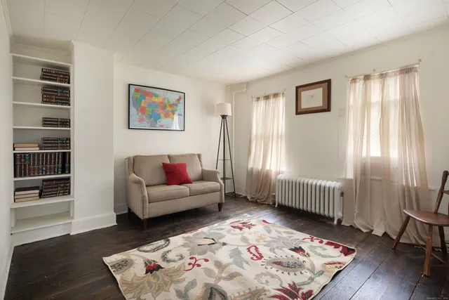 a bedroom with furniture and a window