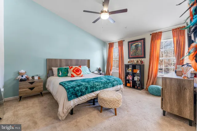 a bedroom with a bed and a large window