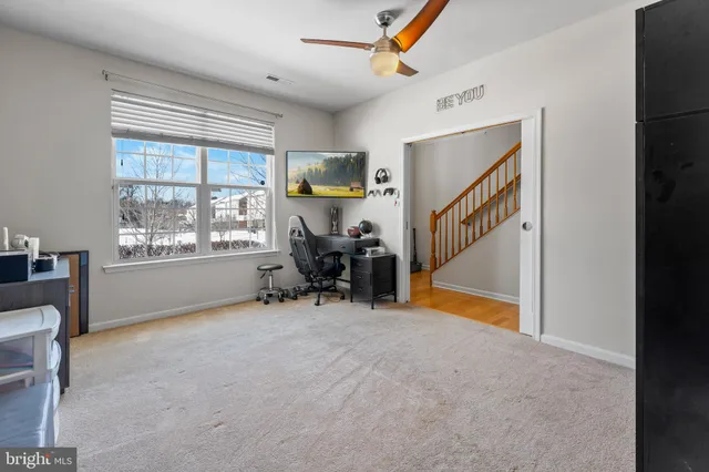 a view of a livingroom with furniture and a window