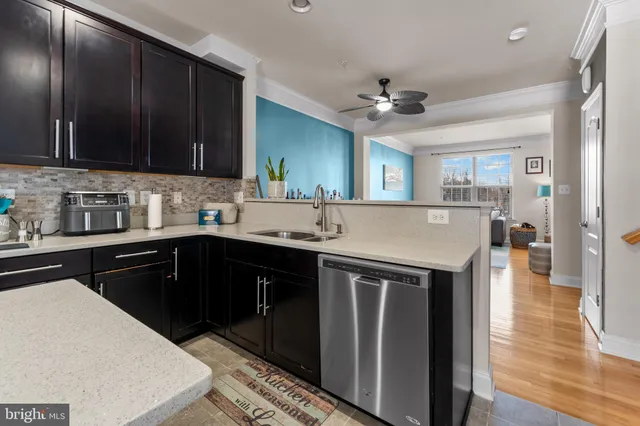 a kitchen with stainless steel appliances granite countertop a sink stove and cabinets