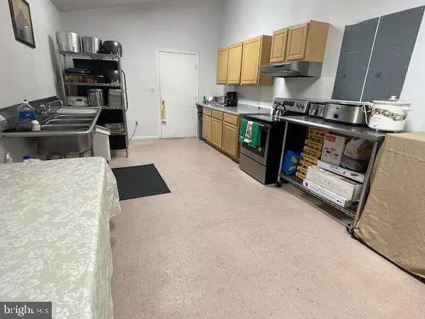 a kitchen with stainless steel appliances a stove a sink and a refrigerator