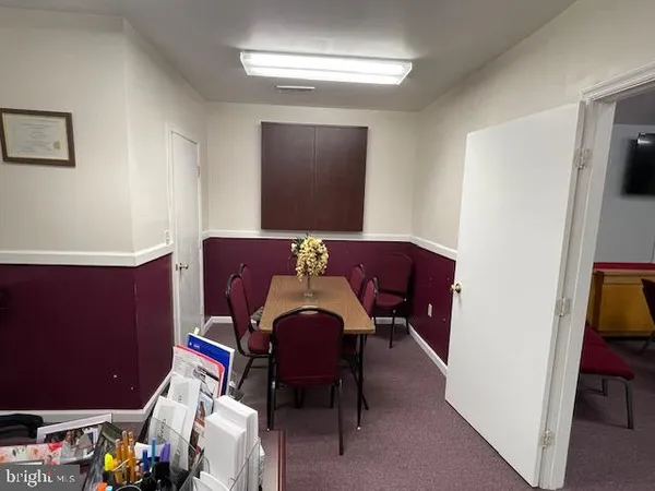a view of a workspace with furniture and a potted plant