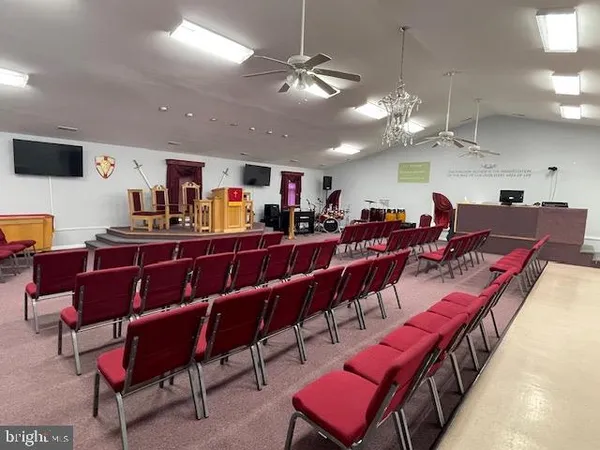 a living room with lots of furniture and a chandelier
