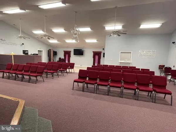 a living room with lots of furniture and a chandelier