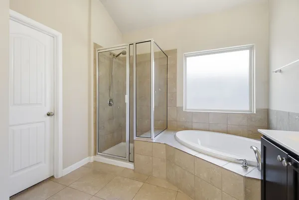 a bathroom with a tub and shower