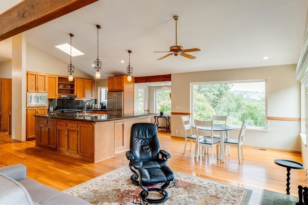 11555 Cenegal Road Atascadero, CA 93422 - Photo 16 of 57 a room with stainless steel appliances granite countertop a stove a kitchen island a dining table and chairs with the view of living room