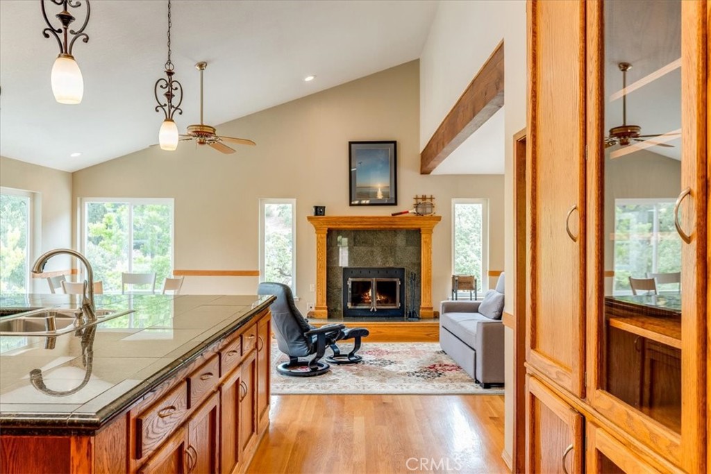 11555 Cenegal Road Atascadero, CA 93422 - Photo 17 of 57 a very nice looking living room with a large window a fireplace and a chandelier