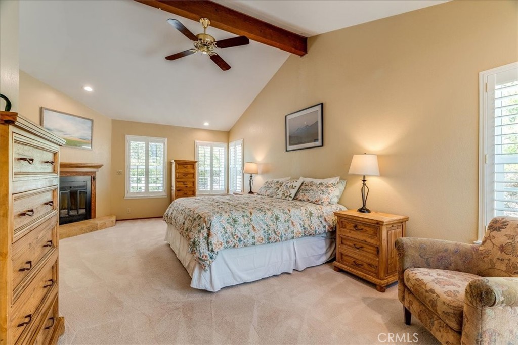 11555 Cenegal Road Atascadero, CA 93422 - Photo 26 of 57 a spacious bedroom with a bed a couch and a ceiling fan