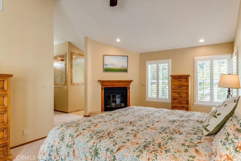 11555 Cenegal Road Atascadero, CA 93422 - Photo 27 of 57 a bedroom with a bed and a dresser with mirror