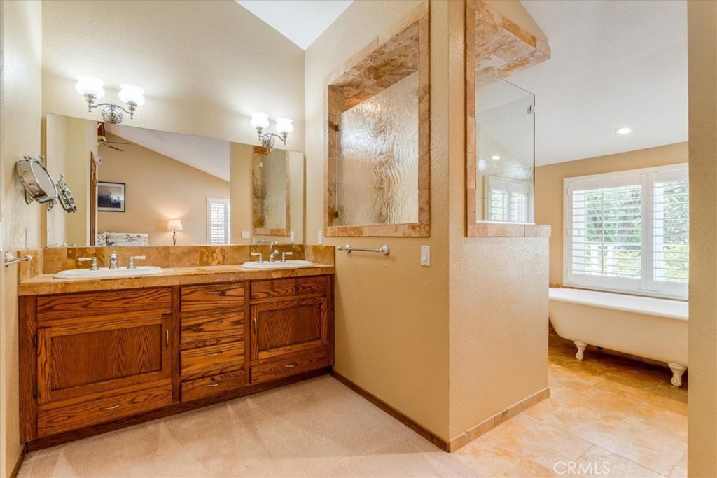 11555 Cenegal Road Atascadero, CA 93422 - Photo 30 of 57 a spacious bathroom with a granite countertop sink and a mirror
