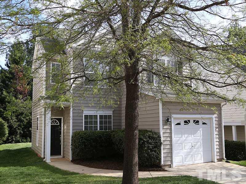 8336 Tie Stone Way Raleigh, NC 27613 - Photo 1 of 20 a view of a brick house with a large windows and a tree