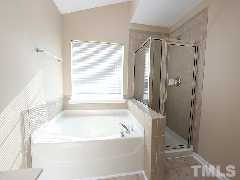8336 Tie Stone Way Raleigh, NC 27613 - Photo 12 of 20 a bathroom with a bathtub and a shower