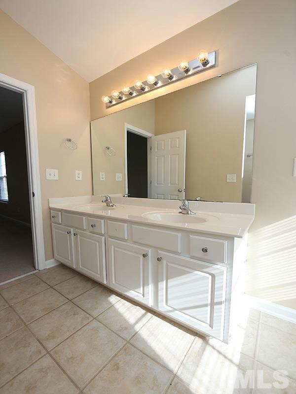 8336 Tie Stone Way Raleigh, NC 27613 - Photo 13 of 20 a bathroom with a double vanity sink a and a mirror
