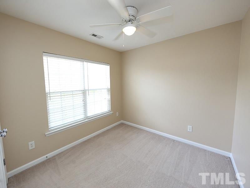 8336 Tie Stone Way Raleigh, NC 27613 - Photo 15 of 20 an empty room with a window and a fan