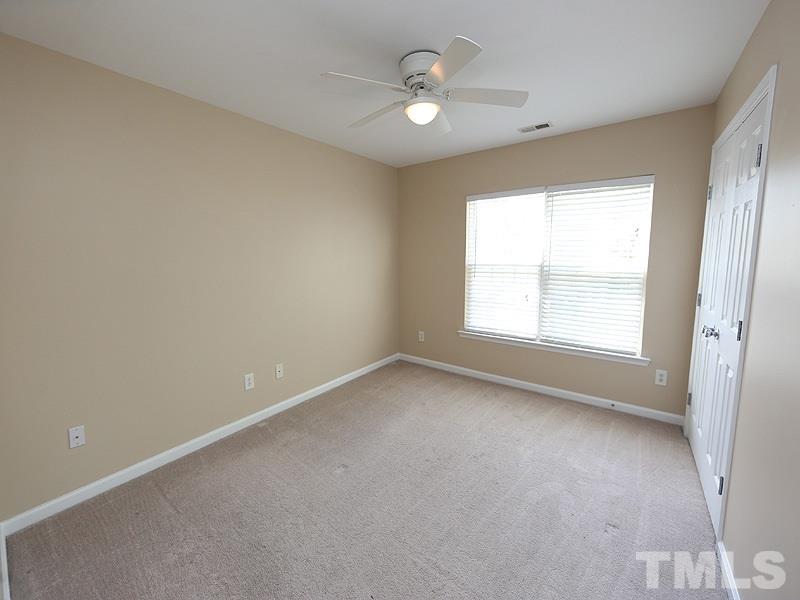 8336 Tie Stone Way Raleigh, NC 27613 - Photo 16 of 20 an empty room with a window and a ceiling fan