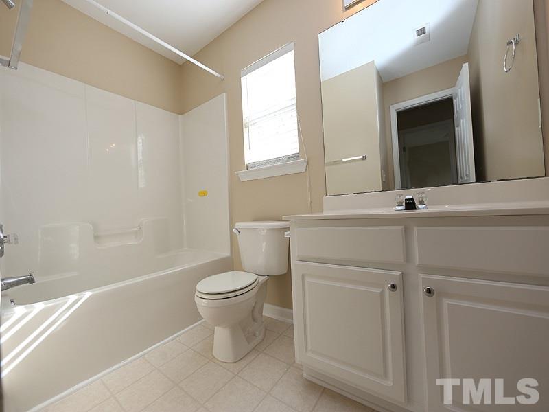 8336 Tie Stone Way Raleigh, NC 27613 - Photo 17 of 20 a bathroom with a sink a toilet and shower